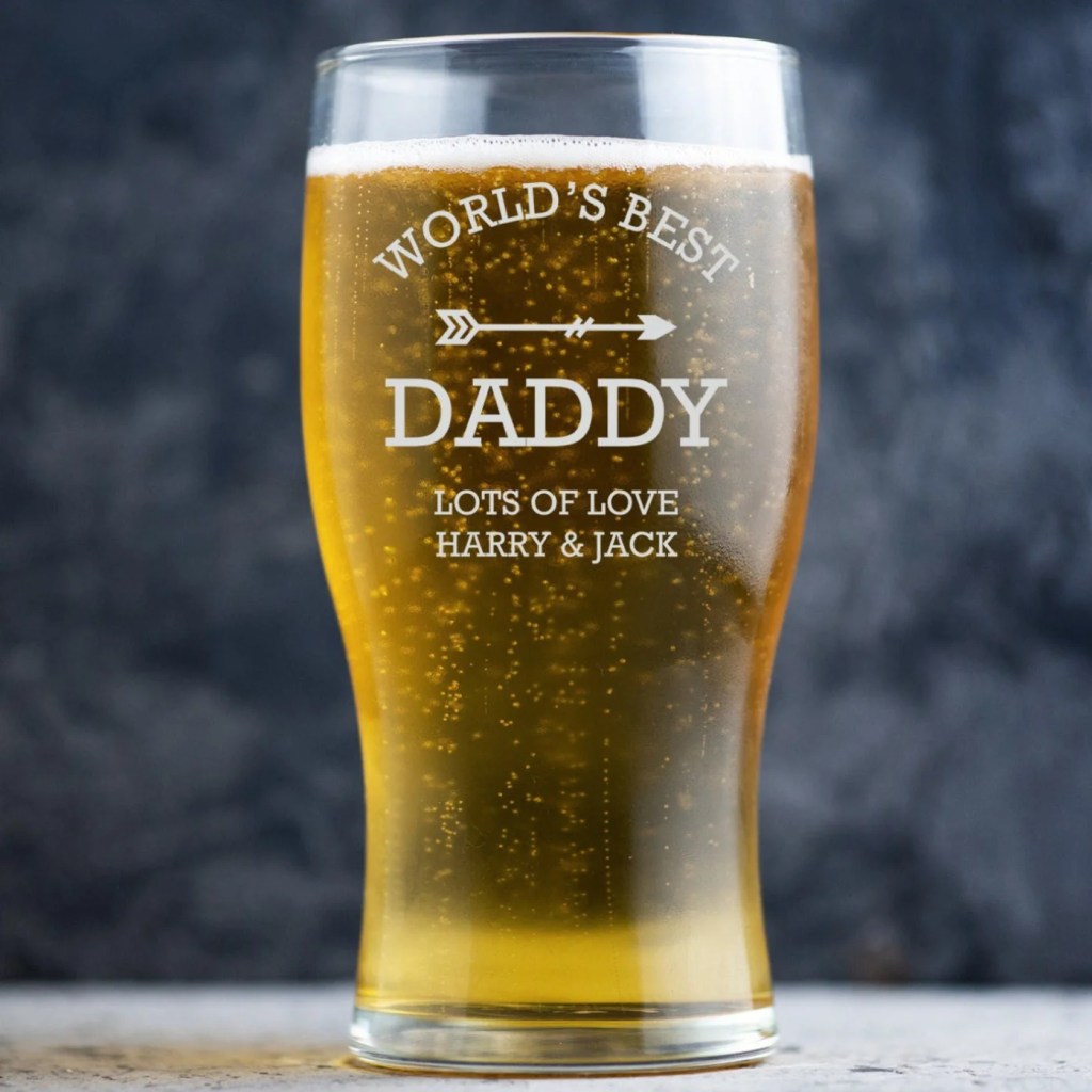 A pint glass filled almost to the top with beer or lager. The text 'world's best Daddy, lots of love Harry & Jack' are in a white text on the outside of the glass.